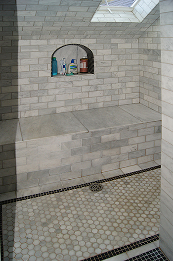 This is a bathroom with tiled walls and ceiling in a converted attic in an English Cottage style residence in the town of Martinez, CA.